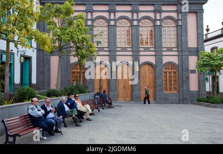 Eldery people on benches at Placa de la Constitucion, Arucas, Grand Canary, Canary islands, Spain, Europe Stock Photo