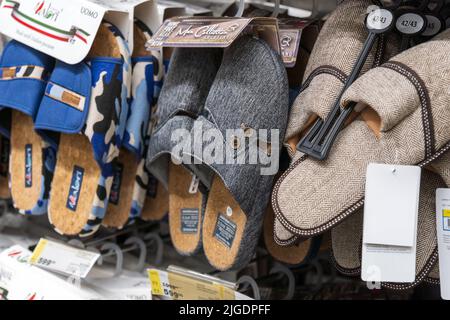 Tyumen, Russia-April 14 2022: Various brand of slippers display for sale at hypermarket. Selective focus Stock Photo