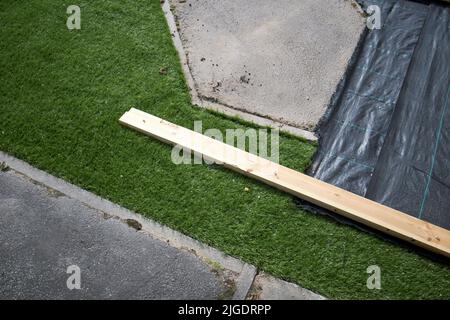 laying artificial grass in a garden in the uk Stock Photo