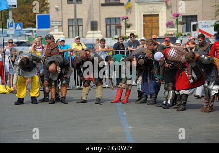 Reenactors dressed in armor of an Old Russian footmen dancing on a street after fight reconstruction. July 7, 2019. Kyiv, Ukraine Stock Photo