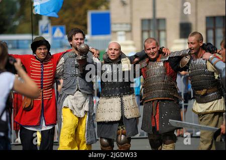 Reenactors dressed in armor of an Old Russian footmen dancing on a street after fight reconstruction. July 7, 2019. Kyiv, Ukraine Stock Photo