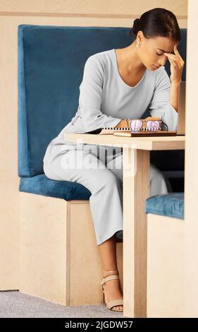 The pressure is piling up. an attractive mature businesswoman looking stressed while working at her desk in the office. Stock Photo