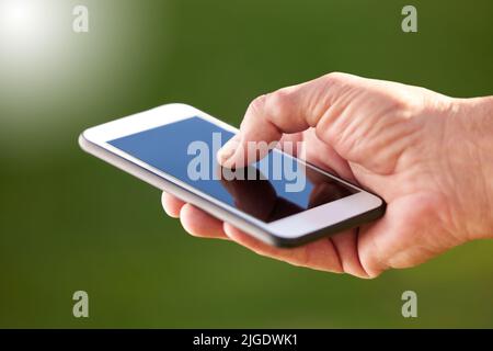 Adapting to new technology. an unrecognisable man using his cellphone. Stock Photo