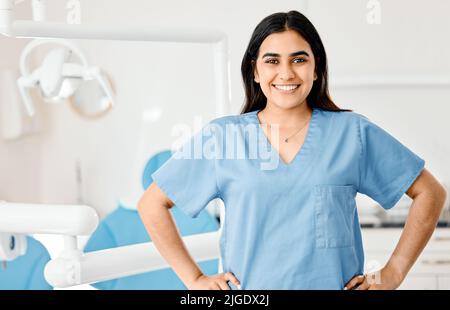 Proud of my dental work. a young nurse working in a dentists office. Stock Photo