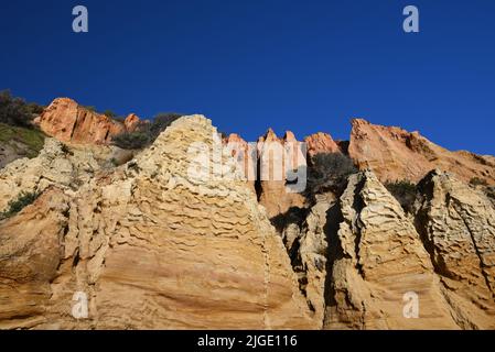 Close view of reddish jagged sandstone formations that make up part of Red Bluff, a natural landmark in metropolitan Melbourne Stock Photo
