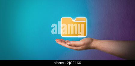 Banner of woman hand showing yellow folder icon with dark blue background. Manage Document System Storage concept. Database technology. File access. Stock Photo