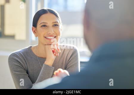 Absorbing all the knowledge she can. an attractive young businesswoman listening attentively to a colleague during a meeting. Stock Photo