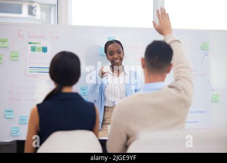 A strong team makes a strong business. a businessman asking a question during a presentation. Stock Photo