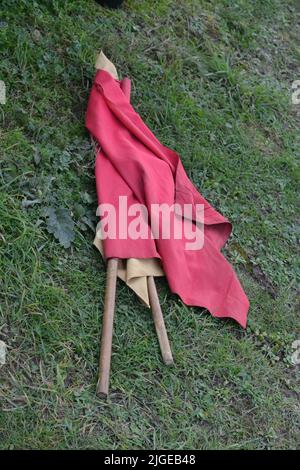 Motorsport Racing Red Flag Laying On The Grass - A Red Flag Is Used To Stop A Race - Motorsport - Warning Flag - Danger Race Stopped - UK Stock Photo