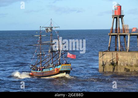 Pirate Ship Returning to Whitby Harbour On A Sunny Day - Pleasure Boat Trip - North Sea - North Yorkshire - UK Stock Photo