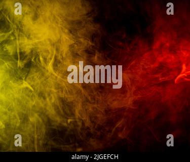 Red-yellow smoke spreads on a black background Stock Photo - Alamy