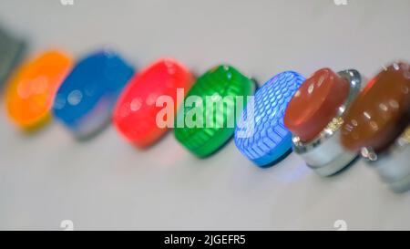 Close-up panel of colored led diode lights. Round brown buttons. Stock Photo