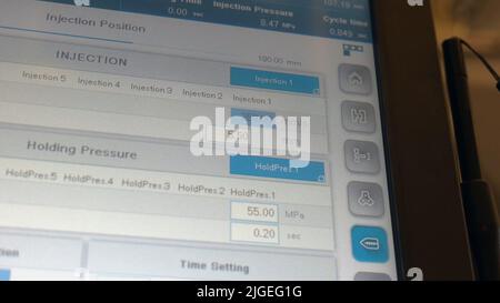 Menu on the large touch screen. Industrial injection molding machine settings. Stock Photo