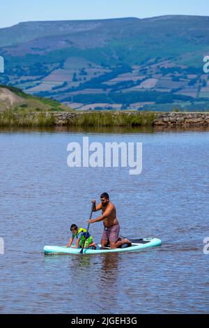 People enjoy the water at Keeper's Pond  near Abergavenny in Monmouthshire, Wales as temperatures soar across the United Kingdom. Stock Photo