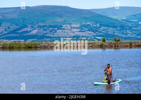 People enjoy the water at Keeper's Pond  near Abergavenny in Monmouthshire, Wales as temperatures soar across the United Kingdom. Stock Photo