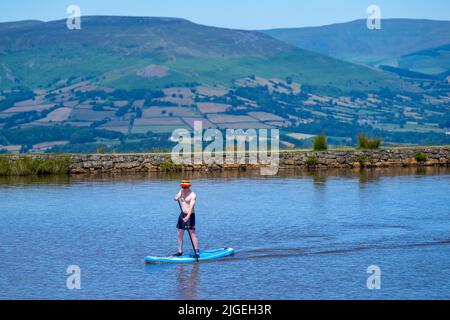 People enjoy the water at Keeper's Pond  near Abergavenny in Monmouthshire, Wales as temperatures soar across the United Kingdom. Stock Photo