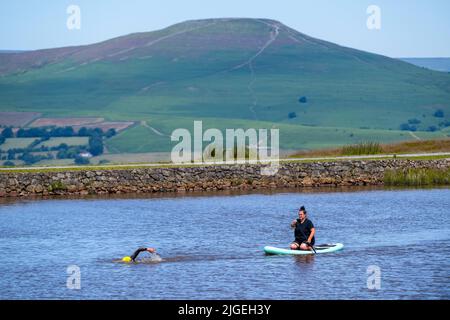 People enjoy the water at Keeper's Pond  near Abergavenny in Monmouthshire, Wales as temperatures soar across the United Kingdom. Stock Photo