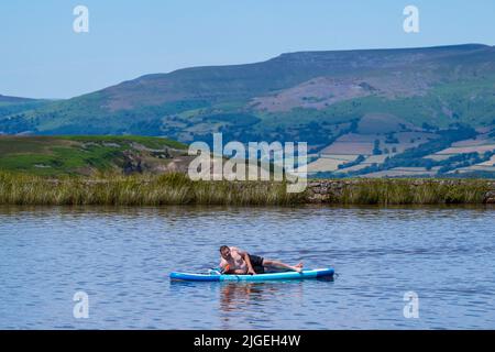 People enjoy the water at Keeper's Pond  near Abergavenny in Monmouthshire, Wales as temperatures soar across the United Kingdom. Stock Photo