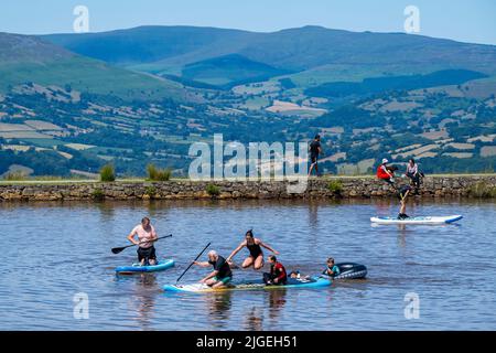 People enjoy the water at Keeper's Pond  near Abergavenny in Monmouthshire, Wales as temperatures soar across the United Kingdom. Stock Photo