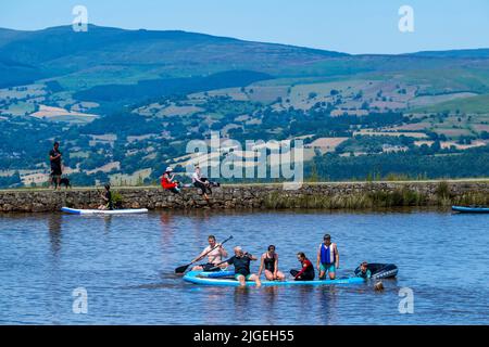 People enjoy the water at Keeper's Pond  near Abergavenny in Monmouthshire, Wales as temperatures soar across the United Kingdom. Stock Photo