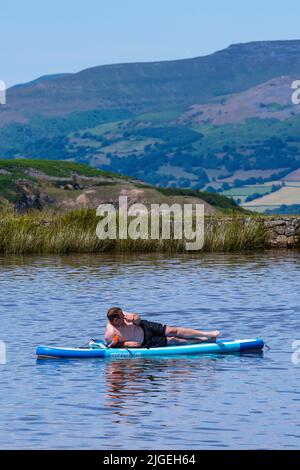 People enjoy the water at Keeper's Pond  near Abergavenny in Monmouthshire, Wales as temperatures soar across the United Kingdom. Stock Photo