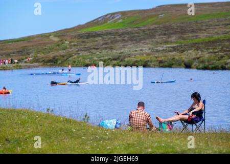 People enjoy the water at Keeper's Pond  near Abergavenny in Monmouthshire, Wales as temperatures soar across the United Kingdom. Stock Photo