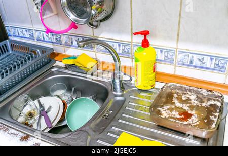 Dirty dishes unwashed in the sink Stock Photo