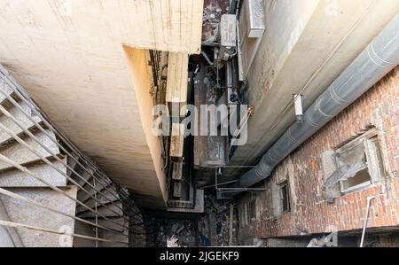 Spiral staircase, Lokking down to shabby yard Stock Photo