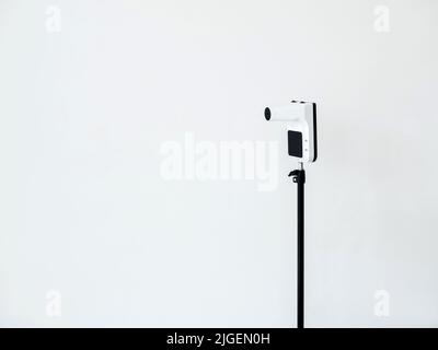 White infrared thermometer, digital thermometer with stand isolated on white background with copy space. Stock Photo