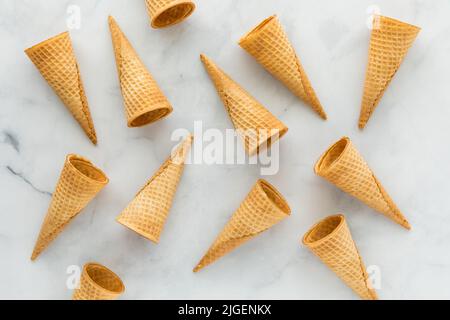 Waffle cones scattered about on a marble background. Stock Photo