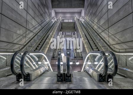 escalators in a grey futuristic light at Amagerbro Metro Station in Copenhagen Stock Photo