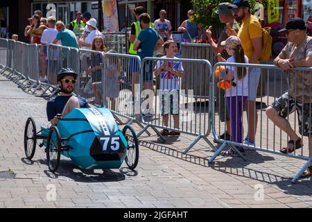 Ringwood, Hampshire, UK. 10th July, 2022. The British Pedal Car Grand Prix first took place in the market town of Ringwood in 1987. The event now attracts thousands of spectators every year to watch the  'cars' as they race around the track in town - crowds flock to see the excitement on a hot sunny day. Credit: Carolyn Jenkins/Alamy Live News Stock Photo