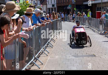 Ringwood, Hampshire, UK. 10th July, 2022. The British Pedal Car Grand Prix first took place in the market town of Ringwood in 1987. The event now attracts thousands of spectators every year to watch the  'cars' as they race around the track in town - crowds flock to see the excitement on a hot sunny day. Credit: Carolyn Jenkins/Alamy Live News Stock Photo