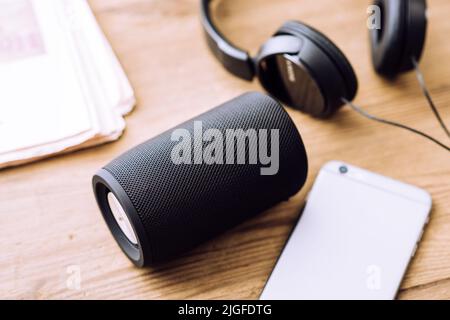 Black mini wireless portable bluetooth speaker for music listening. Stock Photo
