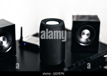 Black mini wireless portable bluetooth speaker for music listening. Stock Photo