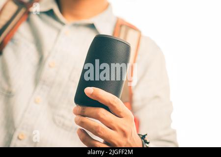 Black mini wireless portable bluetooth speaker for music listening. Stock Photo