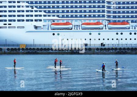 Alesund, Norway - July 2018. Transportation  ferry cruise passenger and people canoeing in Norway , Alesund, Norway. Stock Photo