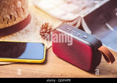 relaxing concept, close up red wireless portable speaker for music listening. Stock Photo