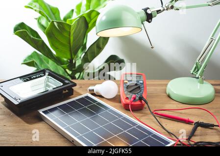 Photovoltaic or solar cell panel with multimeter. green energy concept. Stock Photo