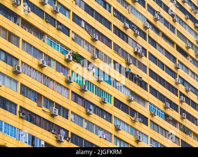 Multiple air conditioner units on exterior of apartment building, Republic of Singapore.  Air conditioners emit  greenhouse gases known as hydrofluoro Stock Photo
