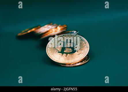 Stack of bitcoins on a green table . Stock Photo