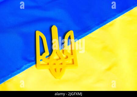 The flag of Ukraine on which the coat of arms is depicted. Texture flag of Ukraine. Ukrainian symbols. War 2022. Stock Photo