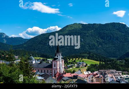 Beautiful aerial view of Mariazell town with Mariazell basilica on sunny summer day with the Alps and blue sky cloud, Styria, Austria Stock Photo