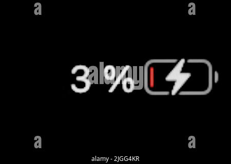 Smartphone charged battery level indicator - three, 3 percent: close up macro Stock Photo