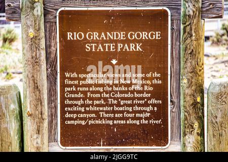 2021 05 21 Taos New Mexico USA - Grungy scarred sign for Rio Grande Gorge State Park mounted on rustic wooden frame Stock Photo