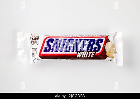 Snickers bar with fresh roasted peanuts, caramel and nougat covered in white chocolate. Stock Photo