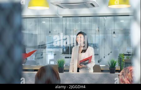 Business team training with businesswoman speaking and smiling broadly. Co working office center. Stock Photo