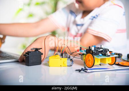 Premium Photo  Asian little boy programming code to robot machine