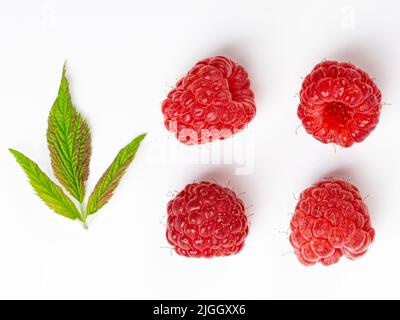 Ripe raspberries with leaf isolated on a white background Stock Photo