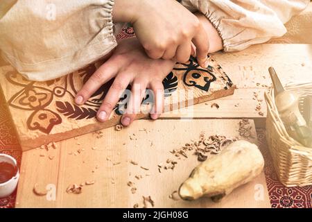 Wooden stamps for medieval ink printing on fabric and vintage clothing. Reconstruction of the events of the Middle Ages in Europe. Stock Photo